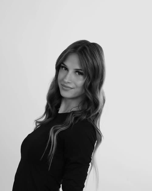 Petra, assistant bridal hairstylist, in a black-and-white studio portrait with long waves