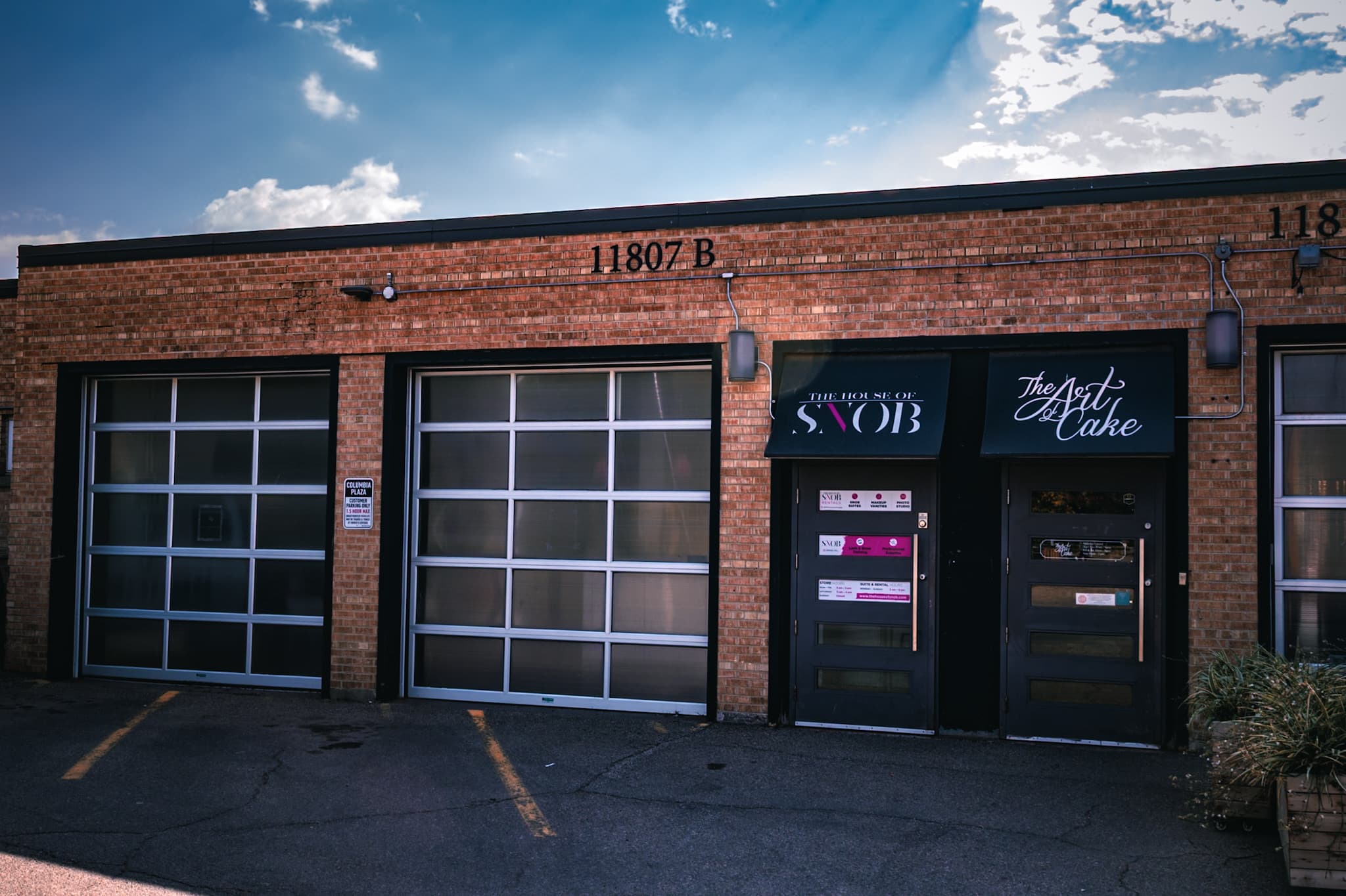 Brick storefront with glass garage doors and the House of Snob sign in Edmonton